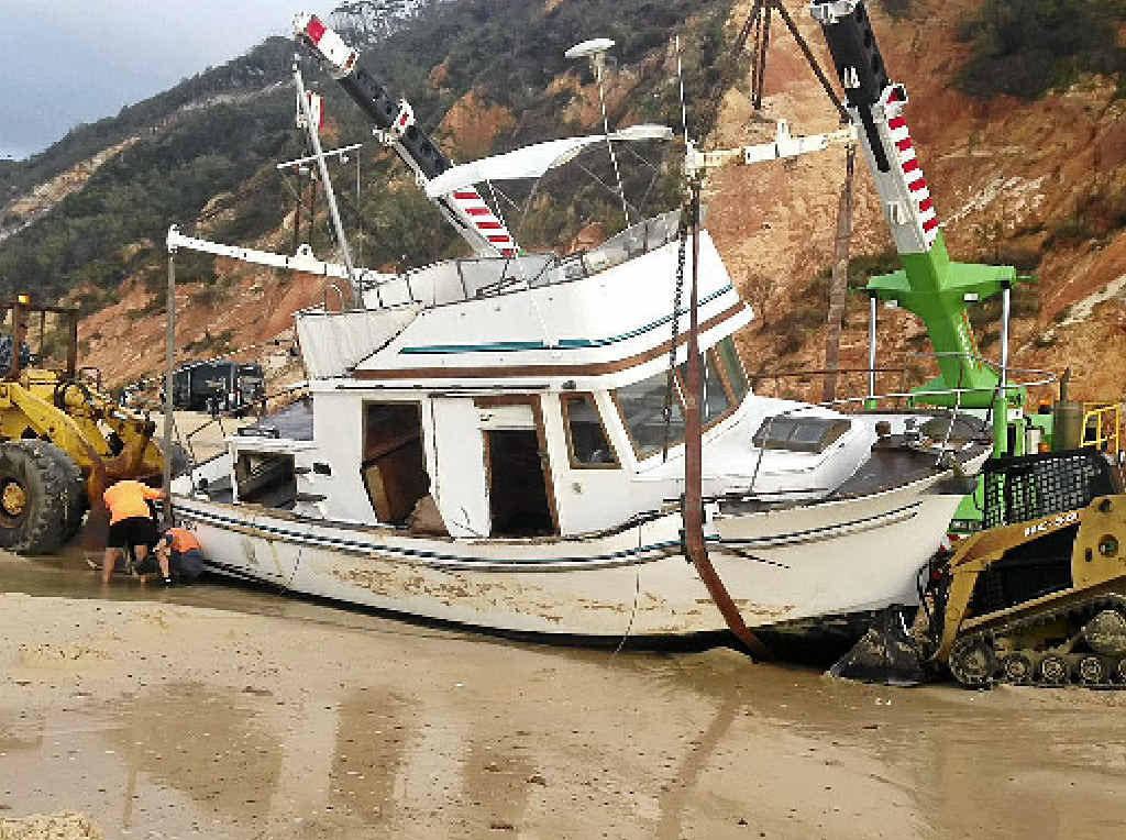 GONE IN PIECES: Hopes of saving the Ping Wo II, which ran aground near Rainbow Beach, faded as a recovery team tried to lift it yesterday. GONE IN PIECES: Hopes of saving the Ping Wo II, which ran aground near Rainbow Beach, faded as a recovery team tried to lift it yesterday.